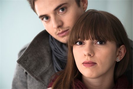 front (the front of) - Close-up, Head and Shoulder Portrait of Young Couple Looking at Camera, Studio Shot on Grey Background Stock Photo - Premium Royalty-Free, Code: 600-06486259