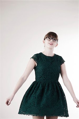 simsearch:600-06486284,k - Portrait of Young Woman wearing Green, Lace Dress and Horn-rimmed Eyeglasses, Looking Upward, Studio Shot on White Background Stock Photo - Premium Royalty-Free, Code: 600-06486277