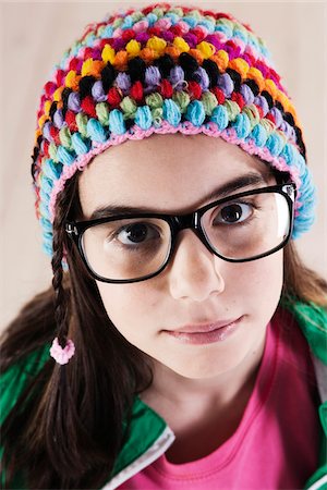 face girl preteen picture - Close-up Portrait of Girl wearing Woolen Hat and Horn-rimmed Eyeglasses, Looking at Camera, Studio Shot on White Background Stock Photo - Premium Royalty-Free, Code: 600-06486286