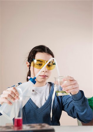 Girl wearing Safety Glasses Pouring Liquid into Graduated Cylinder, Mannheim, Baden-Wurttemberg, Germany Stock Photo - Premium Royalty-Free, Code: 600-06486456