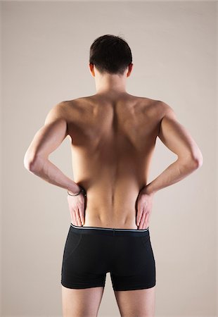 Backview of Young Man wearing Underwear with Hands on Hips, Studio Shot Stock Photo - Premium Royalty-Free, Code: 600-06505866