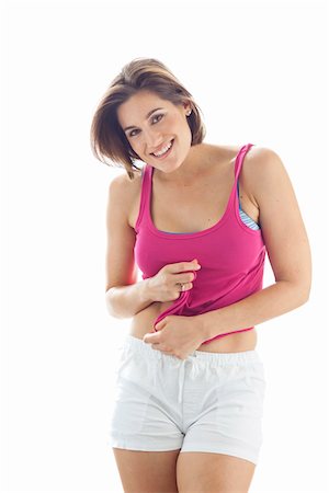 Portrait of Young Woman wearing Tank Top and Shorts in Studio Stock Photo - Premium Royalty-Free, Code: 600-06531594