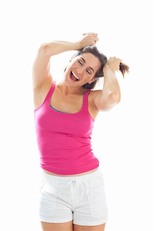 pulling - Portrait of Young Woman wearing Tank Top and Shorts Pulling Hair in Studio Photographie de stock - Premium Libres de Droits, Code: 600-06531601