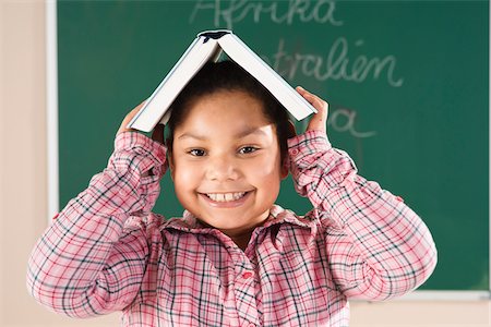 simsearch:600-07192152,k - Girl With Textbook on her Head in Classroom, Baden-Wurttemberg, Germany Stock Photo - Premium Royalty-Free, Code: 600-06548599