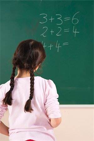 pensive child - Girl Answering Question at Blackboard in Classroom, Baden-Wurttemberg, Germany Stock Photo - Premium Royalty-Free, Code: 600-06548615