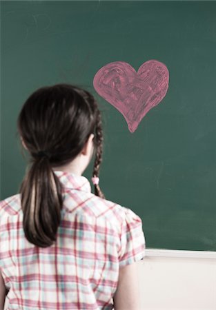 simsearch:600-07192152,k - Back of Girl Looking at Heart drawn in Chalk on Chalkboard in Classroom Stock Photo - Premium Royalty-Free, Code: 600-06543531