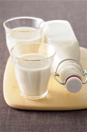 Two Glasses of Milk with Milk Bottle on Cutting Board Stock Photo - Premium Royalty-Free, Code: 600-06553467