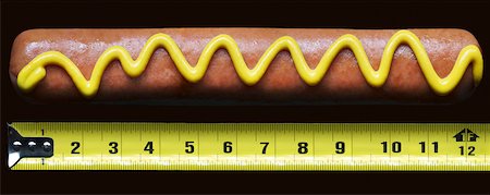 food on black - Hotdog with mustard beside measuring tape Stock Photo - Premium Royalty-Free, Code: 600-06570960