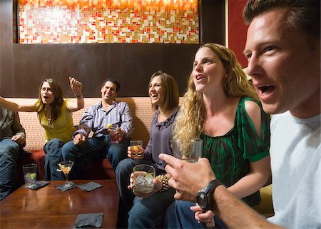 drinking bar and lounge - Men and women socializing in a bar in the city. Group of festive, smiling people celebrating with drinks. California USA Stock Photo - Premium Royalty-Free, Code: 600-06571137