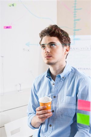 drawing (visual aid) - Young Man Working in an Office, Looking Through Glass Board, Germany Stock Photo - Premium Royalty-Free, Code: 600-06620954