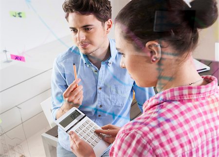 drawing (visual aid) - Young Man and Young Woman Working in an Office, Looking Through Glass Board, Germany Stock Photo - Premium Royalty-Free, Code: 600-06620961