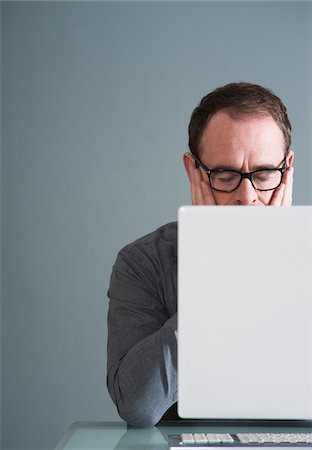 Businessman Using Computer in Studio Stock Photo - Premium Royalty-Free, Code: 600-06645880