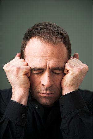 Head and Shoulders Portrait of Mature Man Eyes Closed and Fists by Head Stock Photo - Premium Royalty-Free, Code: 600-06675167