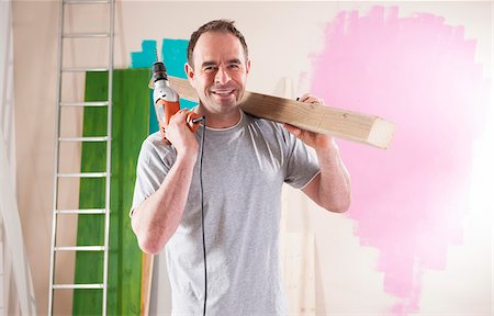 pictures of a man holding a drill - Portrait of Mature Man Renovating his Home Stock Photo - Premium Royalty-Free, Code: 600-06679375