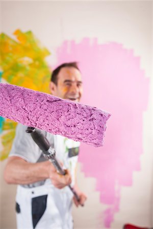 smile at work - Portrait of Mature Man with Paint Roller Renovating his Home Stock Photo - Premium Royalty-Free, Code: 600-06679395