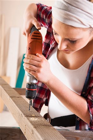 do it yourself - Studio Shot of Young Woman Drilling Lumber Stock Photo - Premium Royalty-Free, Code: 600-06671748
