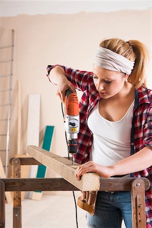 simsearch:600-06671767,k - Studio Shot of Young Woman Drilling Lumber Stock Photo - Premium Royalty-Free, Code: 600-06671751