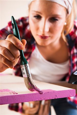 diy or home improvement - Studio Shot of Young Woman Painting Lumber Stock Photo - Premium Royalty-Free, Code: 600-06671763