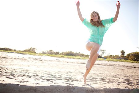 Young Woman Smiling and Jumping on Beach, Palm Beach Gardens, Palm Beach County, Florida, USA Foto de stock - Sin royalties Premium, Código: 600-06701903