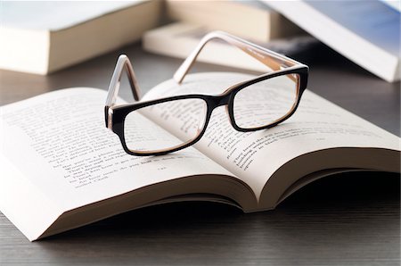 school objects - Close-up of Eyeglasses on Open Book, Studio Shot Stock Photo - Premium Royalty-Free, Code: 600-06702135