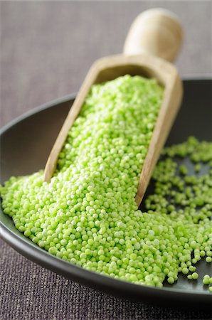 food on colored background - Close-up of Bowl of Quinoa with Scoop. Studio Shot Stock Photo - Premium Royalty-Free, Code: 600-06702137