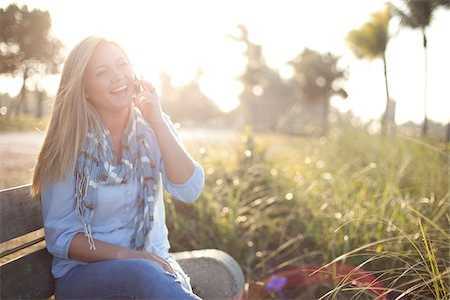 smartphone beach - Young Woman Sitting on Bench at Beach using Cell Phone, Jupiter, Palm Beach County, Florida, USA Stock Photo - Premium Royalty-Free, Code: 600-06732635