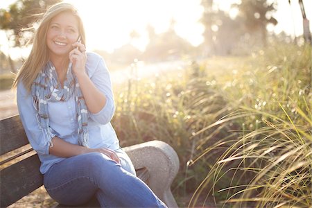 simsearch:600-06531455,k - Young Woman Sitting on Bench at Beach using Cell Phone, Jupiter, Palm Beach County, Florida, USA Stock Photo - Premium Royalty-Free, Code: 600-06732636