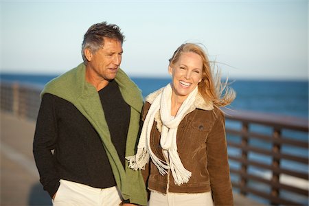 smiling in the wind with scarf - Mature Couple Walking along Pier, Jupiter, Palm Beach County, Florida, USA Stock Photo - Premium Royalty-Free, Code: 600-06732642