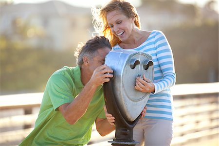 scenic viewer - Mature Couple being Playful looking through Scenic Viewer on Pier, USA Stock Photo - Premium Royalty-Free, Code: 600-06752301