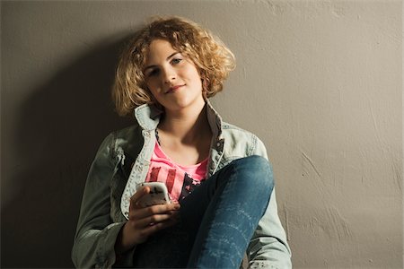 simsearch:600-06752514,k - Teenage Girl using Cell Phone, Studio Shot Photographie de stock - Premium Libres de Droits, Code: 600-06752482