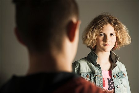 simsearch:600-06752492,k - Teenage Girl looking at Teenage Boy, Studio Shot Stock Photo - Premium Royalty-Free, Code: 600-06752493