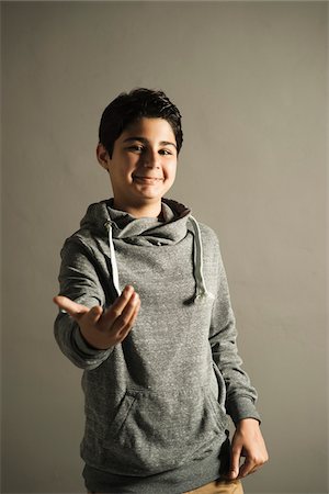 simsearch:600-06752474,k - Portrait of Teenage Boy with Hand out, Studio Shot Stock Photo - Premium Royalty-Free, Code: 600-06752502