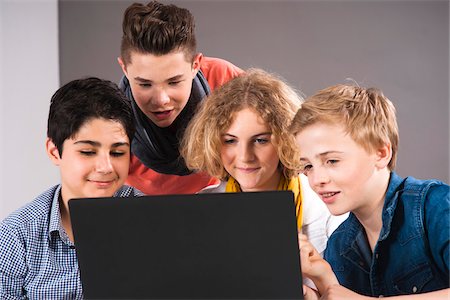 frizzy - Teenagers Looking at Laptop Computer, Studio Shot Stock Photo - Premium Royalty-Free, Code: 600-06752516