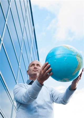 simsearch:600-06773372,k - Businessman Holding Globe Outdoors, Mannheim, Baden-Wurttemberg, Germany Stock Photo - Premium Royalty-Free, Code: 600-06773368