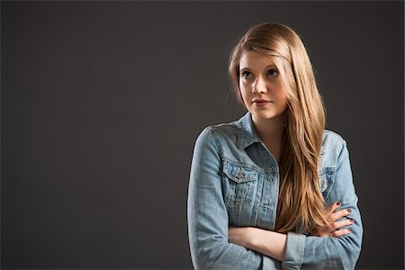 simsearch:640-06051056,k - Portrait of young woman with long, blond hair, studio shot on grey background Stock Photo - Premium Royalty-Free, Code: 600-06786766