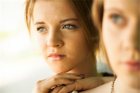 day dreaming eyes - Close-up portrait of teenage girl with blurred young woman in foreground Stock Photo - Premium Royalty-Free, Code: 600-06786778