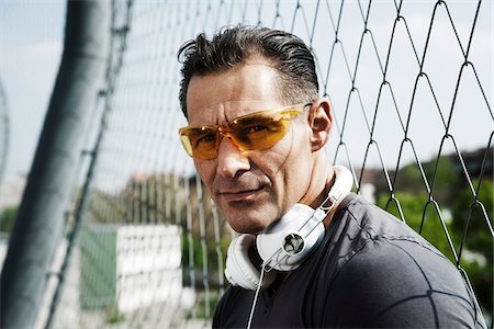 Close-up portrait of mature man wearing sunglasses with headphones around neck, Germany Stockbilder - Premium RF Lizenzfrei, Bildnummer: 600-06786838