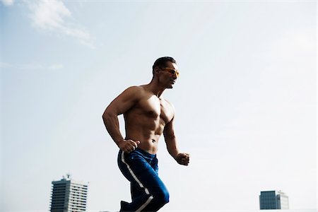 europe city blue - Mature man running against blue sky, Mannheim, Germany Stock Photo - Premium Royalty-Free, Code: 600-06786866