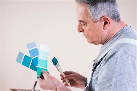 Senior Man looking at Paint Colour Samples, Studio Shot Stock Photo - Premium Royalty-Free, Code: 600-06787007