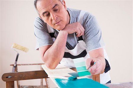 painting man - Senior Man Comparing Paint Sample to Painted Board, Studio Shot Stock Photo - Premium Royalty-Free, Code: 600-06787009