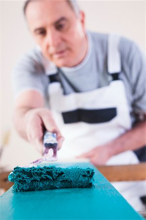 painting man - Senior Man Painting Board with Blue Paint, Studio Shot Stock Photo - Premium Royalty-Free, Code: 600-06787003