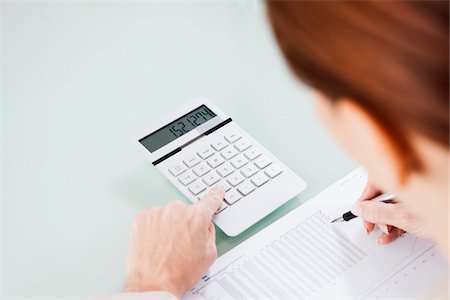 Over the Shoulder View of Mature Woman Working on Budget in Office Stock Photo - Premium Royalty-Free, Code: 600-06787018