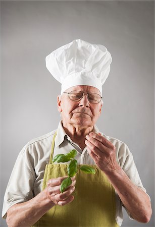 simsearch:600-06787022,k - Elderly Man wearing Chef's Hat holding Basil Stock Photo - Premium Royalty-Free, Code: 600-06787027