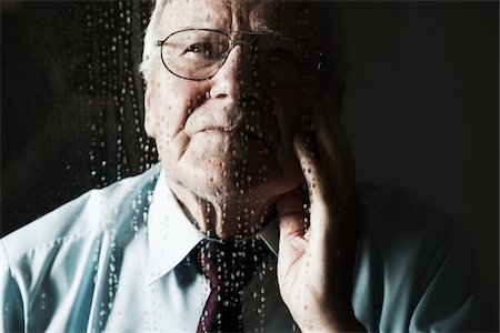 Elderly Man Looking out Window on Rainy Day Foto de stock - Sin royalties Premium, Código: 600-06787029