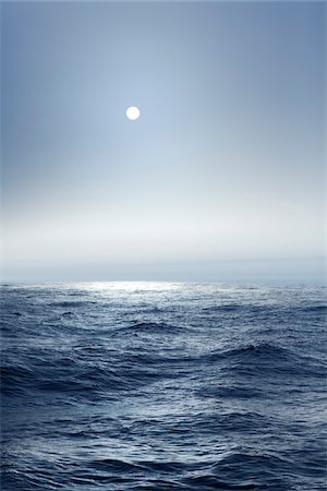 The Atlantic ocean illuminated off the coast of Nova Scotia in fog with the sun shining through. Stock Photo - Premium Royalty-Free, Code: 600-06782111