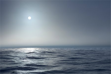 The Atlantic ocean illuminated off the coast of Nova Scotia in fog with the sun shining through. Stock Photo - Premium Royalty-Free, Code: 600-06782113