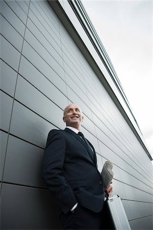 simsearch:632-06118441,k - Portrait of businessman leaning against wall of building, Mannheim, Germany Stock Photo - Premium Royalty-Free, Code: 600-06782187