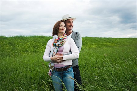 Portrait of mature couple standing in field of grass, embracing, Germany Stock Photo - Premium Royalty-Free, Code: 600-06782242