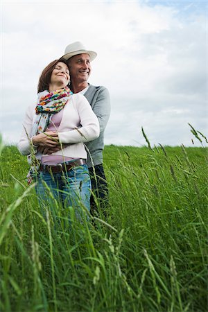 Portrait of mature couple standing in field of grass, embracing, Germany Stock Photo - Premium Royalty-Free, Code: 600-06782243