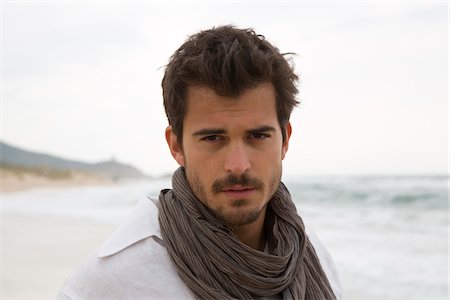Head and Shoulders Portrait of Young Man at Beach, Sardinia, Italy Stock Photo - Premium Royalty-Free, Code: 600-06808908